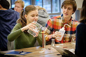 Two students doing chemistry experiment.