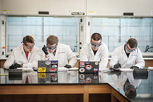 Four students doing lab work.