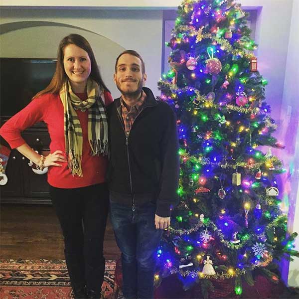 Couple in front of Christmas tree