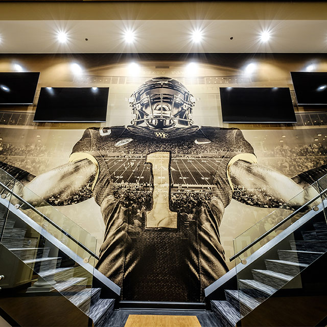 A football player graphic overlooks two staircases