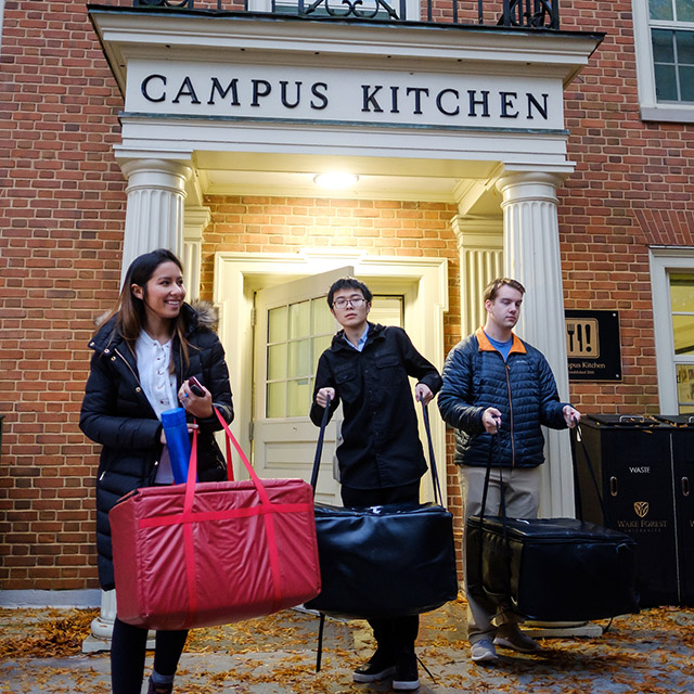 Students leave Campus Kitchen with Thanksgiving meals.