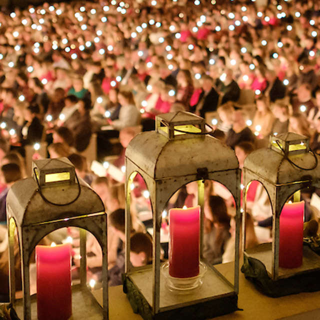 Candles are lit in the audience.