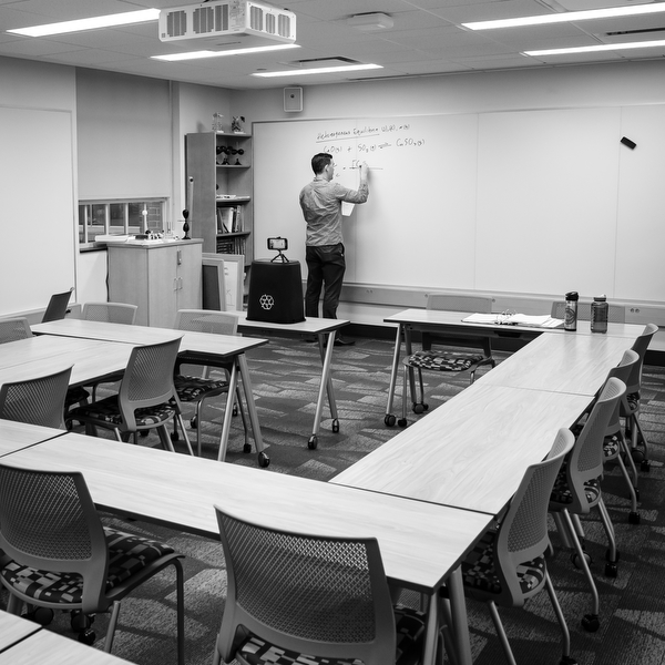 Professor David Wren films his lecture in an empty classroom.