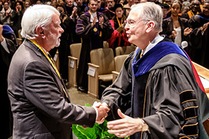 Lou Bissette and President Hatch shake hands