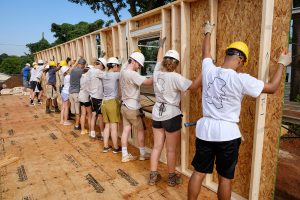 Wake Forest students in the SPARC pre-orientation program lay out and install pre-made wall sections at a Habitat for Humanity build site in East Winston-Salem on Tuesday, August 20, 2019.