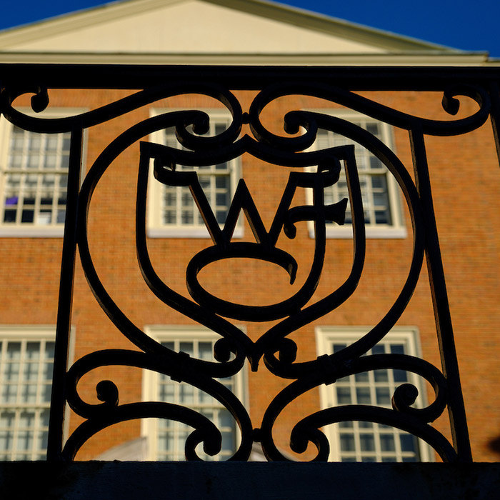 WF ironwork decorates a railing in front of Reynolda Hall