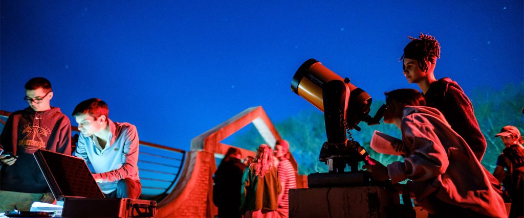 Wake Forest students learn to calculate the diameter of celestial objects using a telescope and basic trigonometry, in their astronomy class in Olin Hall.