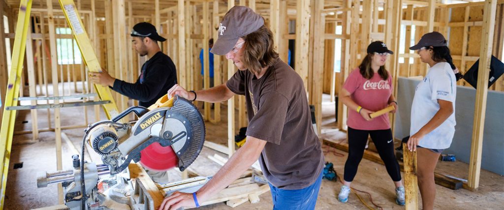 New Wake Forest first year students help build a house with Habitat for Humanity as part of their pre-orientation volunteer Service with the SPARC program.