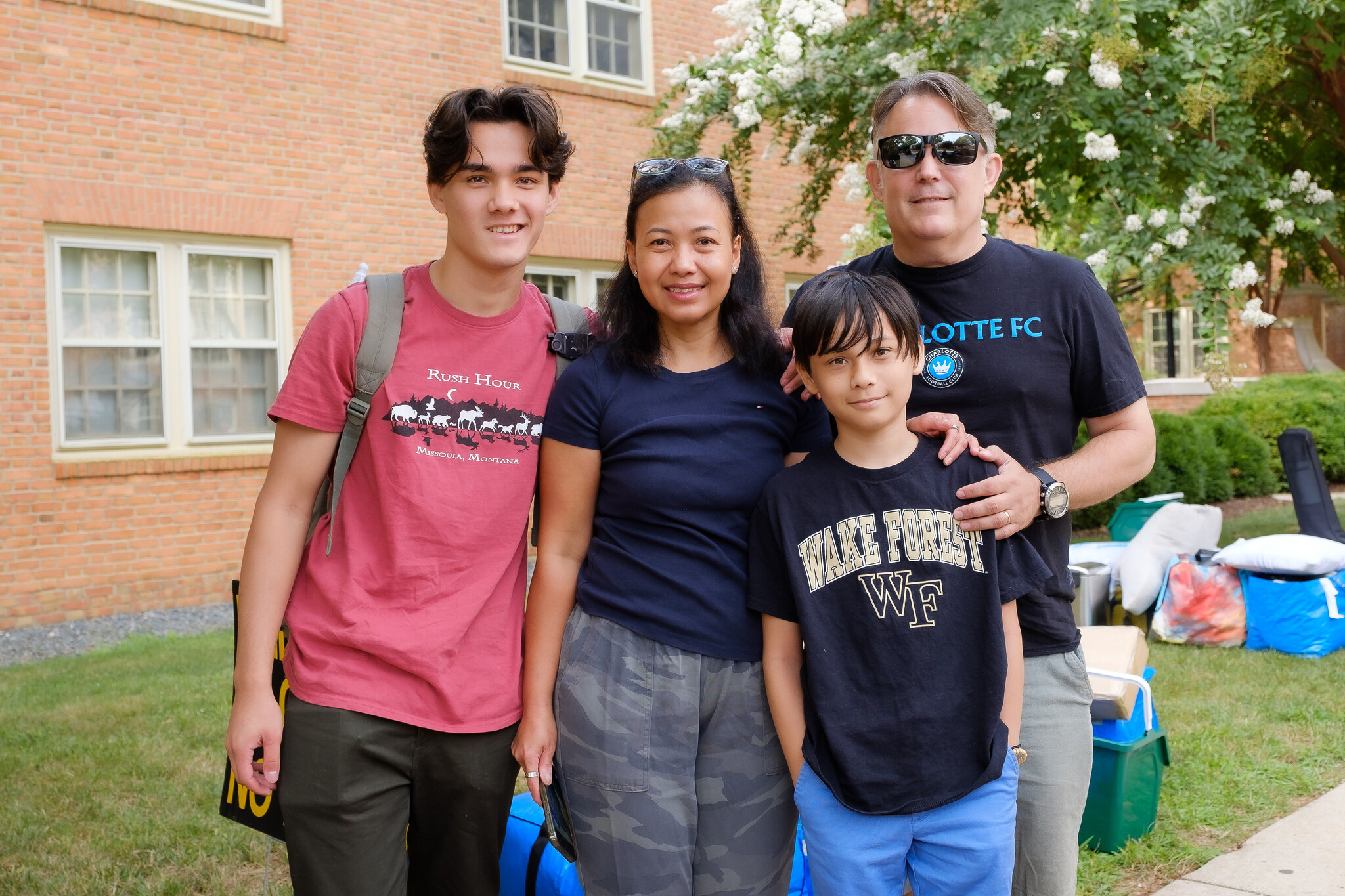 New Wake Forest students move into their residence halls with some help from staff members and athletes on Wednesday, August 17, 2022. Evan Harris (’26) with his family, Brant, Diyah, and Carson, outside Collins Residence.