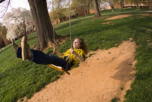 Wake Forest student plays on a swing on Davis Field.