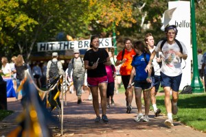 Members of the Wake Forest community run laps around Hearn Plaza to raise money for cancer research in the Hit the Bricks for Brian event, named after football player Brian Piccolo. 