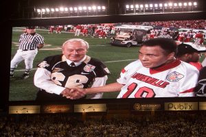 Honorary Wake Forest captain Arnold Palmer meets Louisville captain Muhammad Ali. [Orange Bowl coverage by the Wake Forest University Office of Creative Services. Use of game action and player photos is restricted by the NCAA and the Orange Bowl.]