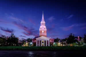 The bell tower of Wait Chapel rises above Hearn Plaza on the campus of Wake Forest University at dusk on Wednesday, October 18, 2017.