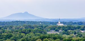 An aerial view of Wait Chapel with Pilot Mountain in the distance, shot from the Nissen building in downtown Winston-Salem.