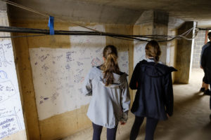 Wake Forest seniors tour the bell tower of Wait Chapel and the tunnels below, signing their names on the wall and taking photos.