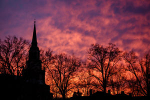 The sunrise illuminates the sky over Wait Chapel on the campus of Wake Forest University.