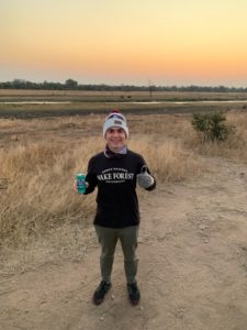 Jordan Diamond '23 in South Africa at Kruger National Park about to embark on an evening safari enjoying a local popular soft drink