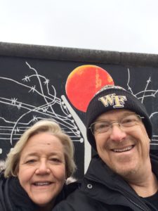 alumni parents Melanie and Rick Harkey at the Berlin Wall