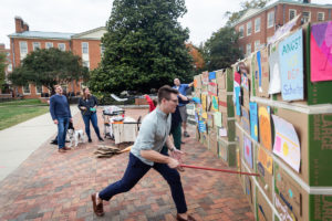 Students and faculty commemorate the 30th anniversary of the falling of the Berlin Wall by hosting a graffiti contest and their own destroying of the wall on Friday, October 25, 2019.