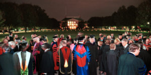 WFU faculty walk out onto the Quad lit with candles after the opening convocation of the new Divinity School. ©2002 Wake Forest University, Office of Creative Services. Photo by Ken Bennett.