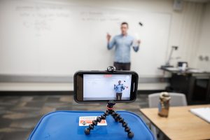 Wake Forest chemistry professor David Wren films his lecture for CHM 280: General Chemistry II with an iPhone in front of an empty classroom in Salem Hall on Wednesday, March 18, 2020, as the university enters its third day of limited operations due to the coronavirus pandemic. Wren polled his students, who asked for video lectures uploaded to Youtube.