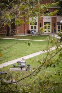 A Wake Forest student works at a table in front of Salem Hall, on the campus of Wake Forest University, Tuesday, September 29, 2020.