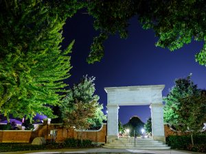 The archway leading to Hearn Plaza is lit at night, on the campus of Wake Forest University, Wednesday, October 7, 2020.