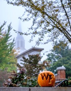 A pumpkin carved with the WF logo stands on a wall outside Hearn Plaza, on the campus of Wake Forest University, Thursday, October 15, 2020.