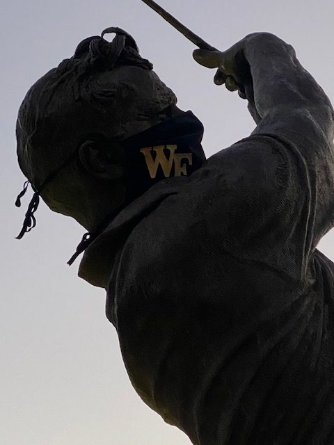 Close up of Arnold Palmer statue with mask