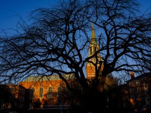 The bell tower of Wait Chapel is visible through the trees, on the campus of Wake Forest University, Monday, November 2, 2020.