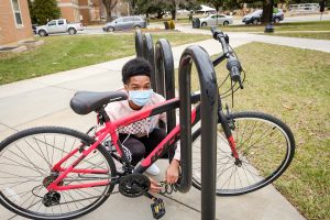 Wake Forest first year Austin Porain (’24) locks up his bike outside Johnson Residence as he returns for the beginning of the Spring 2021 semester on Sunday, January 24, 2021.
