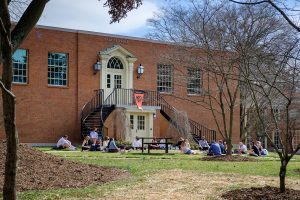 A class moves outside Salem Hall on a warm early spring day, on the campus of Wake Forest University, Tuesday, March 9, 2021.
