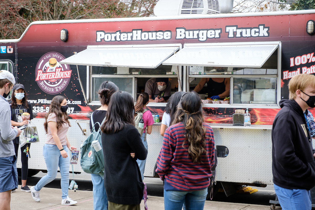 Wake Forest students attend Spring Wake, an outdoor celebration of spring with food trucks, games, and live music, on the campus of Wake Forest University, Saturday, March 13, 2021. It was one of the first large gatherings on campus under the relaxed COVID protocols.
