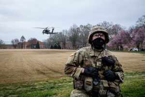 ROTC cadet watches over the helicopter landing