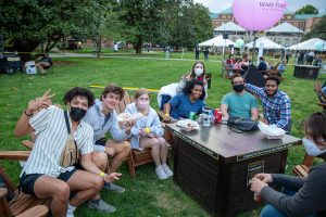 Students sit down at the fire tables for a meal before Wake Forest hosts its first ever WakeChella featuring Wiz Khalifa on Manchester Plaza on Saturday, April 17 2021.