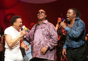 LOS ANGELES - DECEMBER 11: Singer Stevie Wonder (C) and Maurice White (L) and Philip Bailey (R) of the band Earth, Wind and Fire performs during the inaugural "Grammy Jam Fest" at the Wiltern Theatre December 11, 2004 in Los Angeles, California. The event celebrated the music of Earth, Wind and Fire and raised funds for various arts charities. (Photo by Carlo Allegri/Getty Images)