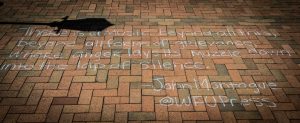 Wake Forest senior Maura Connolly ('14) wrote this poetry on the Hearn Plaza sidewalk as graduate student Nicole Fitzpatrick helped on Wednesday, April 23, 2014. The two were trying to raise awareness of the Wake Forest Press.