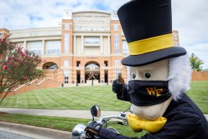 The ESPN Campus Gameday tour bus arrives at Truist Field, led by the Demon Deacon, on the campus of Wake Forest University, Thursday, September 10, 2020.