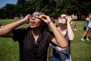 First year students in the Worldwide Wake pre-orientation program watch a near-total eclipse of the sun from the Magnolia Quad on the Wake Forest campus on Monday, August 21, 2017. Indy Cousin, '21, from Kansas City, reacts as she sees the eclipse.