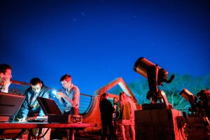 Wake Forest students learn to calculate the diameter of celestial objects using a telescope and basic trigonometry, in their astronomy class in Olin Hall on the evening of Thursday, March 28, 2019. The observation deck is bathed in red light to maintain the students' night vision.