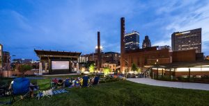 Members of the community attend an open air film presentation in the new Bailey Park in downtown Winston-Salem on Thursday, June 18, 2015. The skyline of Winston-Salem is in the background.