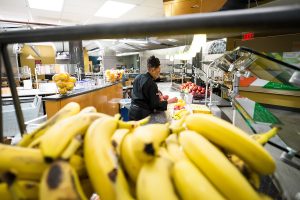 A day in the life of the Reynolda Fresh Foods Company, the Wake Forest dining hall colloquially known as "The Pit," on Tuesday, January 14, 2014. Shirley Washington works at her fruit and salad bar station, putting out the fruit displays that she will be chopping and serving all morning.