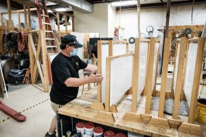 Wake Forest facilities crew members Ben Venable and Jay Huffman build clear acrylic shields for use in public spaces during the COVID-19 pandemic, in the carpentry shop on campus on Monday, July 20, 2020. The frames are made from repurposed bunk bed frames from residence hall renovations.