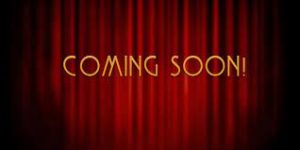 movie theatre curtains with words "coming soon"