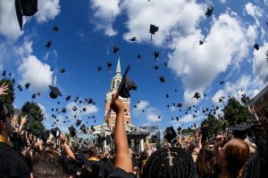 Wake Forest hosts Commencement 2020, delayed 16 months due to COVID, on Hearn Plaza on Saturday, September 18, 2021. Graduates toss their caps to mark the end of the ceremony.