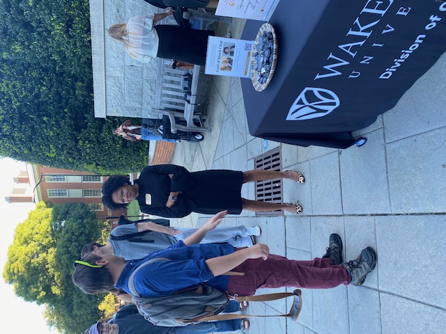 Dr. Shea speaks to a student at Wake Up Wednesday