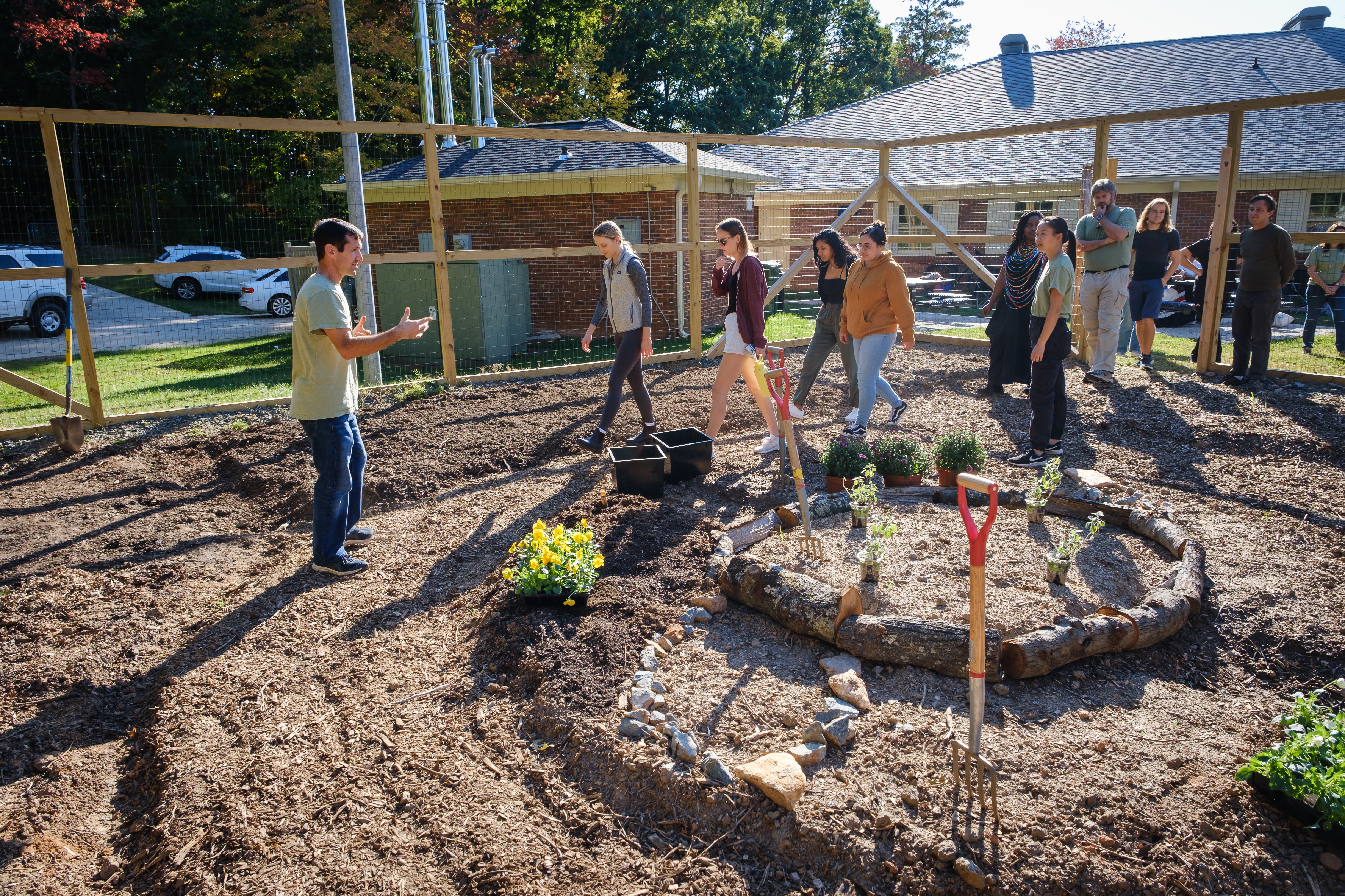 Members of the Wake Forest community celebrate Indigenous Peoples Day at the Three Sisters Garden, on the campus of Wake Forest University on Monday, October 10, 2022. Attendees work in the garden, sowing seeds, mulching, and planting elderberry saplings.