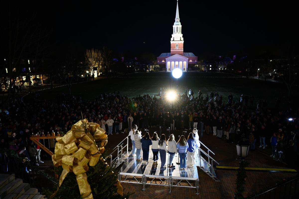 A view of the stage and Wait chapel in the distance. Wake Forest University students and senior leadership gather for the annual Lighting of the Quad ceremony on Hearn Plaza on Tuesday, November 28, 2023.