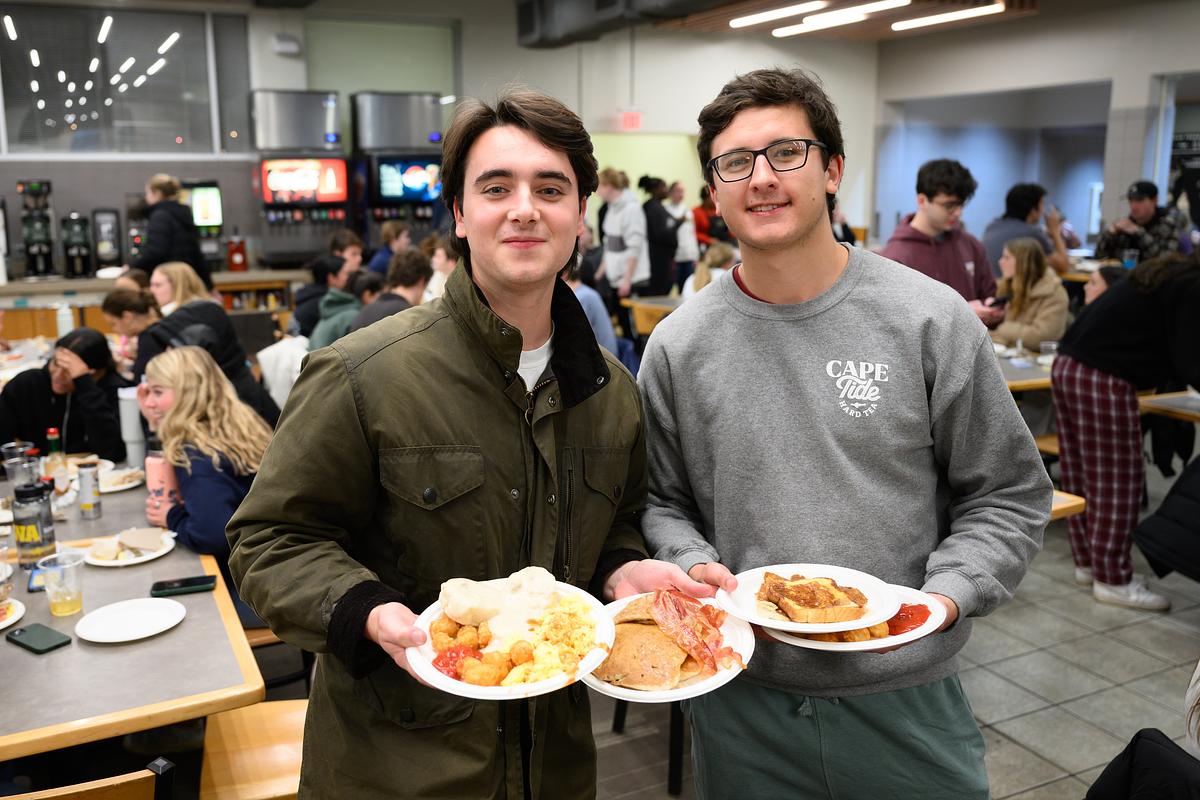 Wake Forest University students enjoy a late night breakfast served by faculty and staff before the start of exams, in the Pit on Wednesday, December 6, 2023.