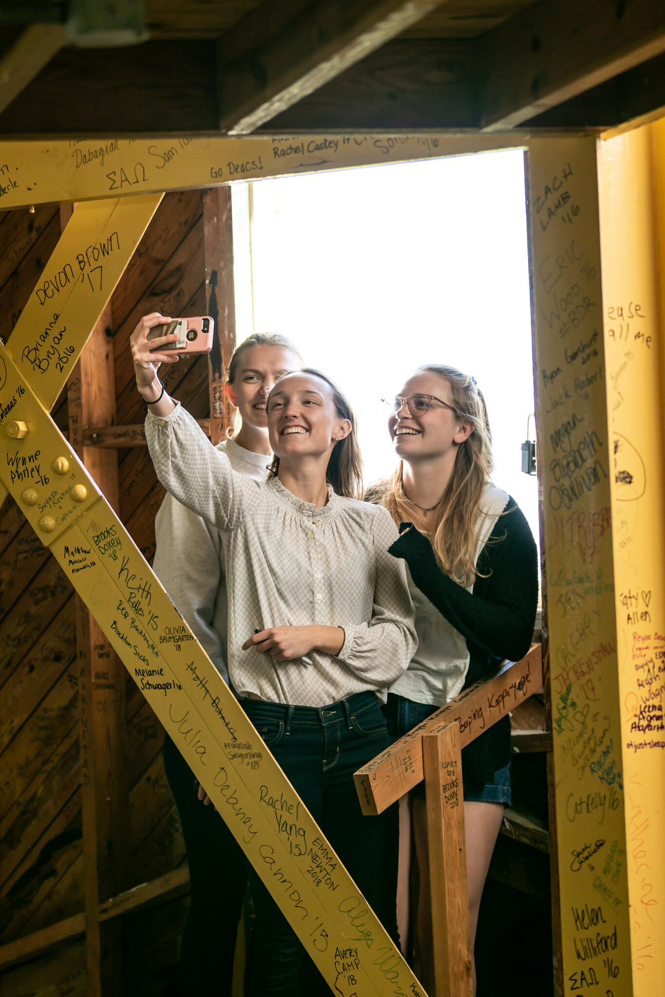 Wake Forest seniors tour the bell tower of Wait Chapel and sign their names on the walls, on Monday, April 15, 2019.